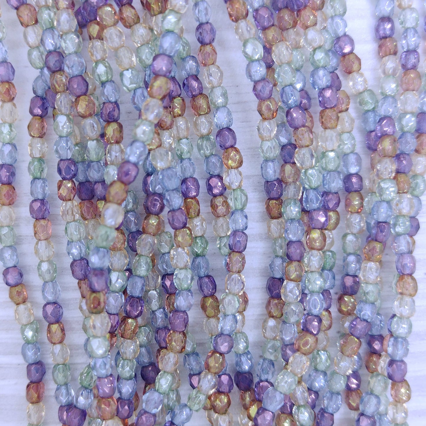 50 x 3mm faceted beads in Crystal Picasso Lustre