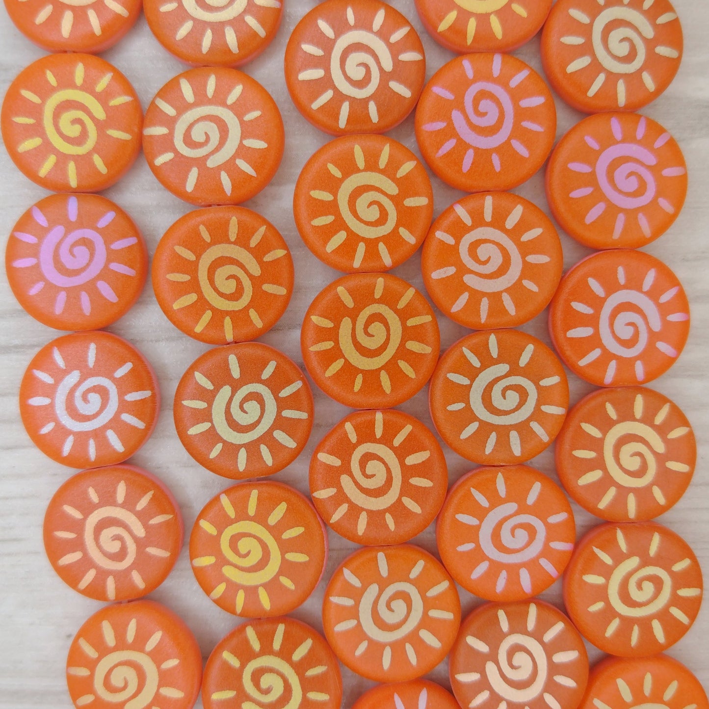 8 x 16mm discs in Matt Orange with laser etched Sun