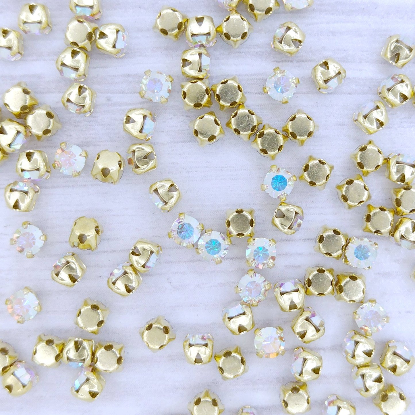 SS12 or 3.3mm in Crystal AB with Gold sew-on setting (Preciosa)