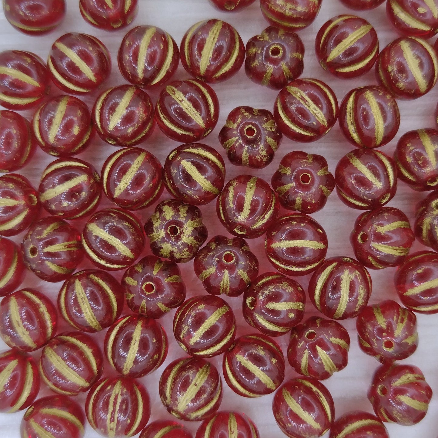10 x 8mm melon beads in Transparent Siam Ruby with Gold