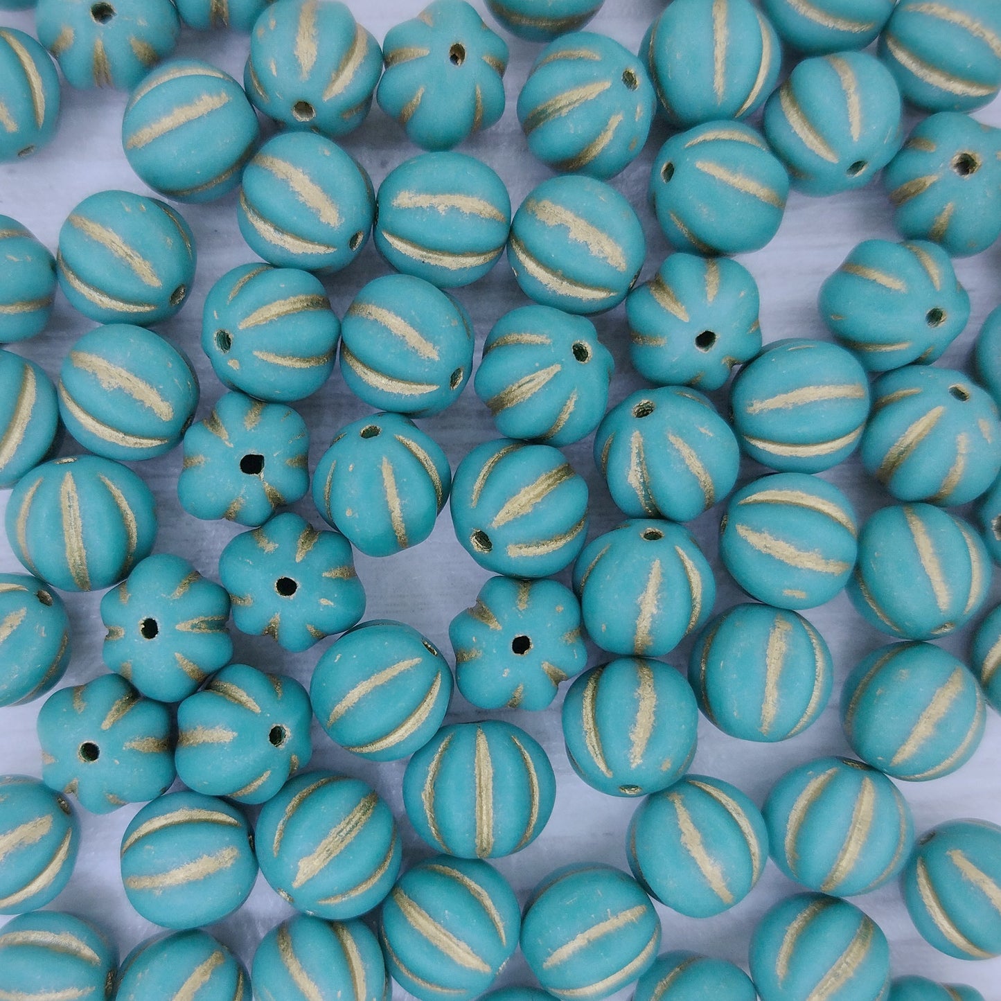 10 x 8mm melon beads in Matt Turquoise with Gold