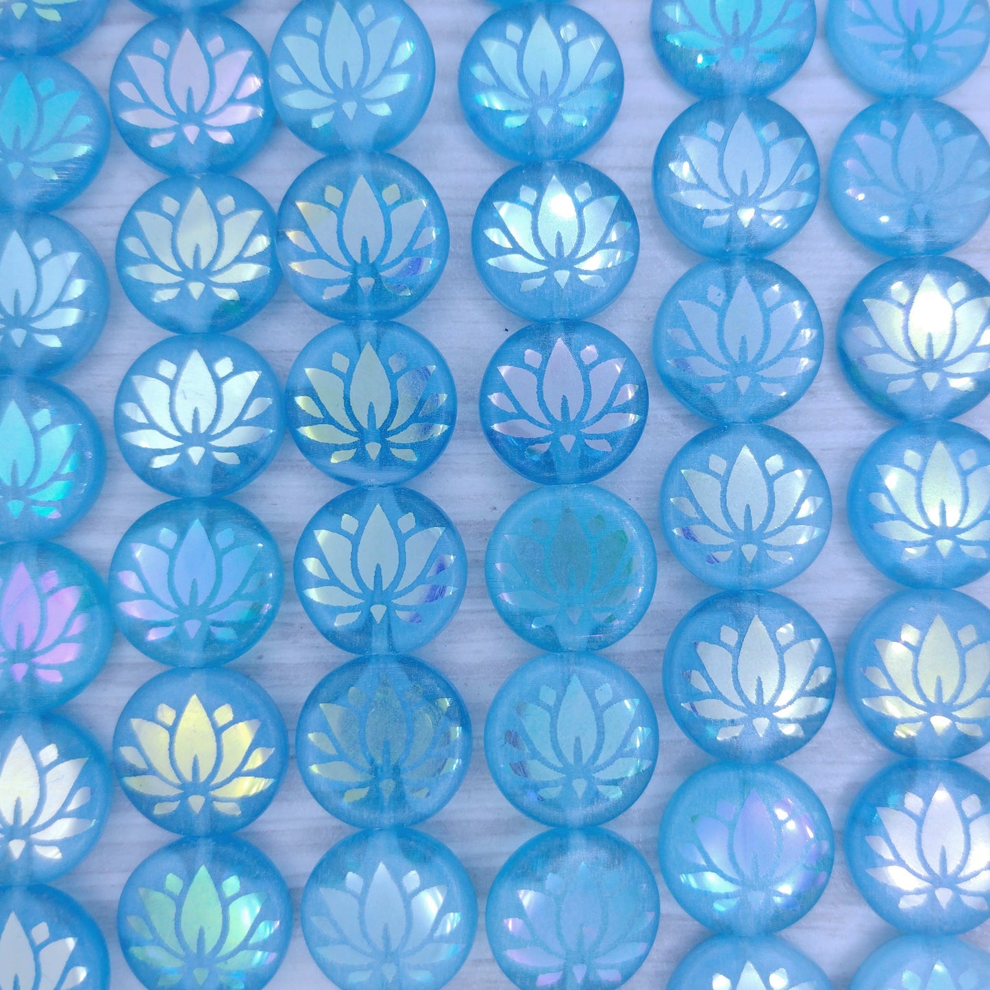 8 x 14mm disc beads in Milky Blue and Crystal with large laser etched Lily Pad