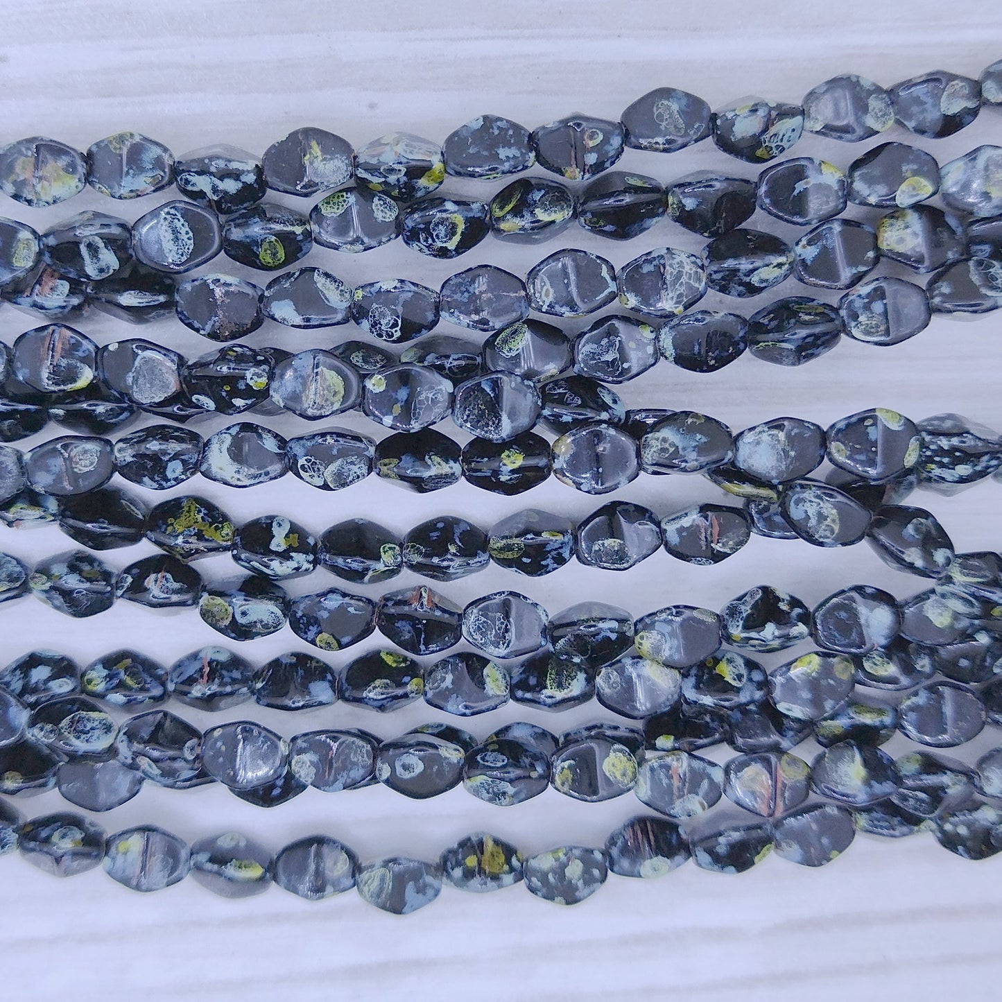 37 x Pinch beads in Black Picasso (3x5mm)