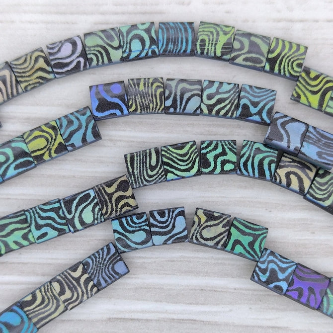 25 x Tila beads in Matt Black with Contours design