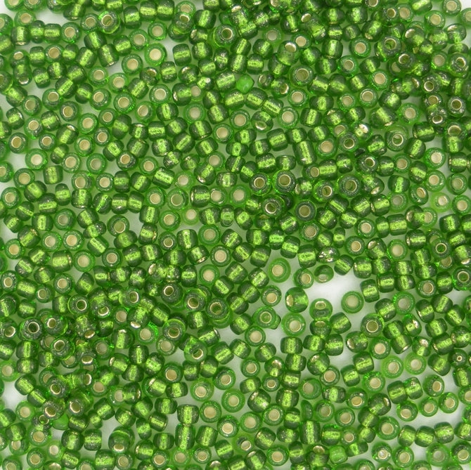 10g uneven size 11/0 seed beads in Silver lined Green