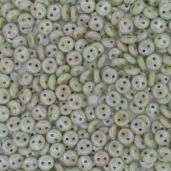 25 x two hole lentils in Alabaster/Green Lustre