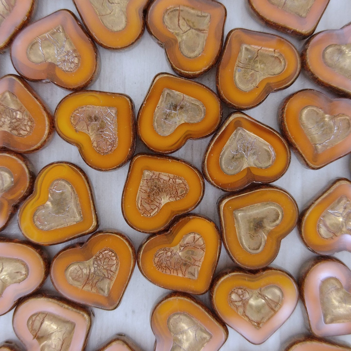 Pair of 14x12mm TC Heart in Heart beads in Orange Opal with Bronze