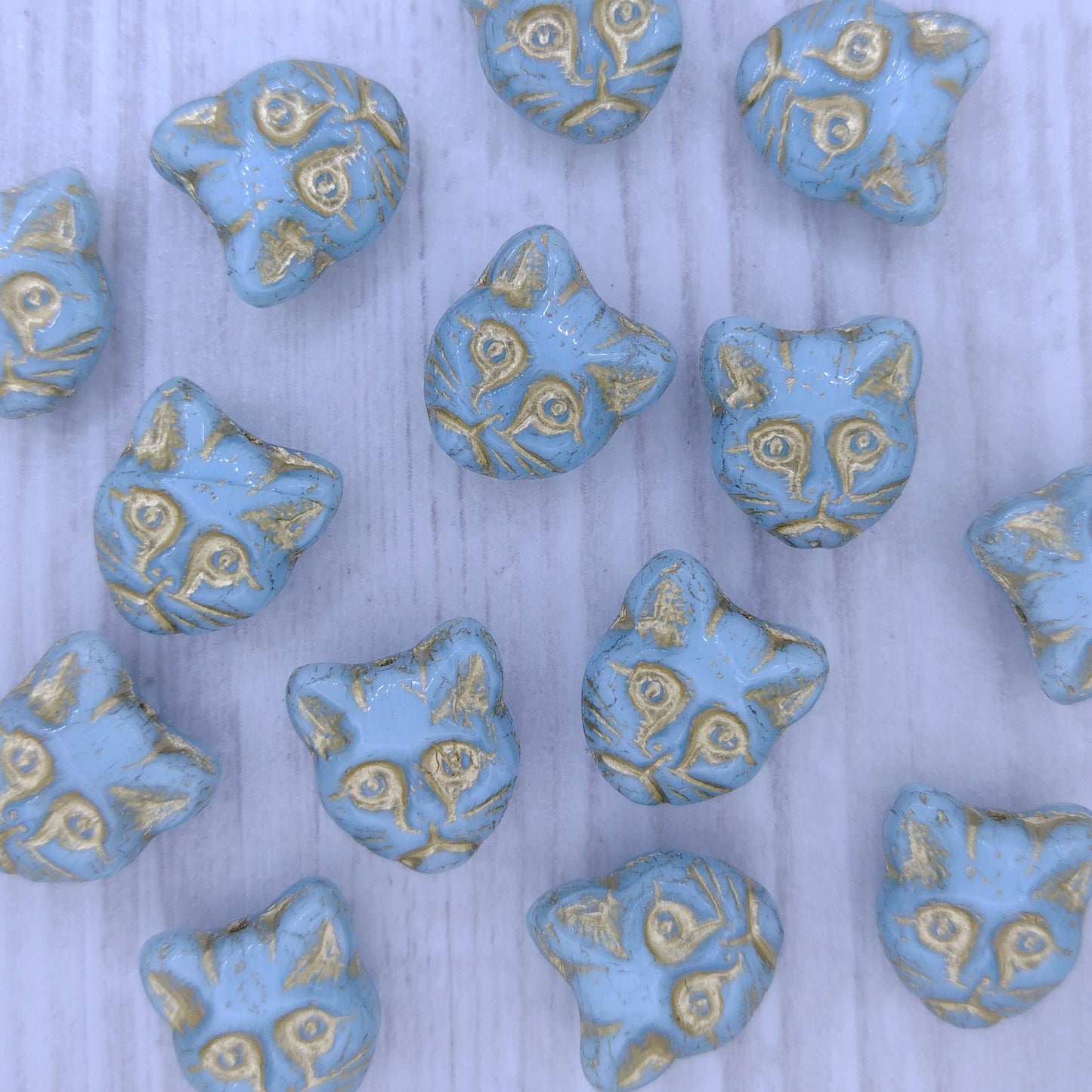 2 x 13mm Cat head beads in Light Blue with Gold