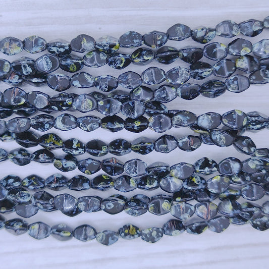 37 x Pinch beads in Black Picasso (3x5mm)