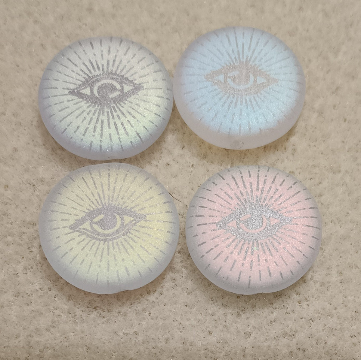 4 x 17mm discs in Matt Crystal with laser etched Eye