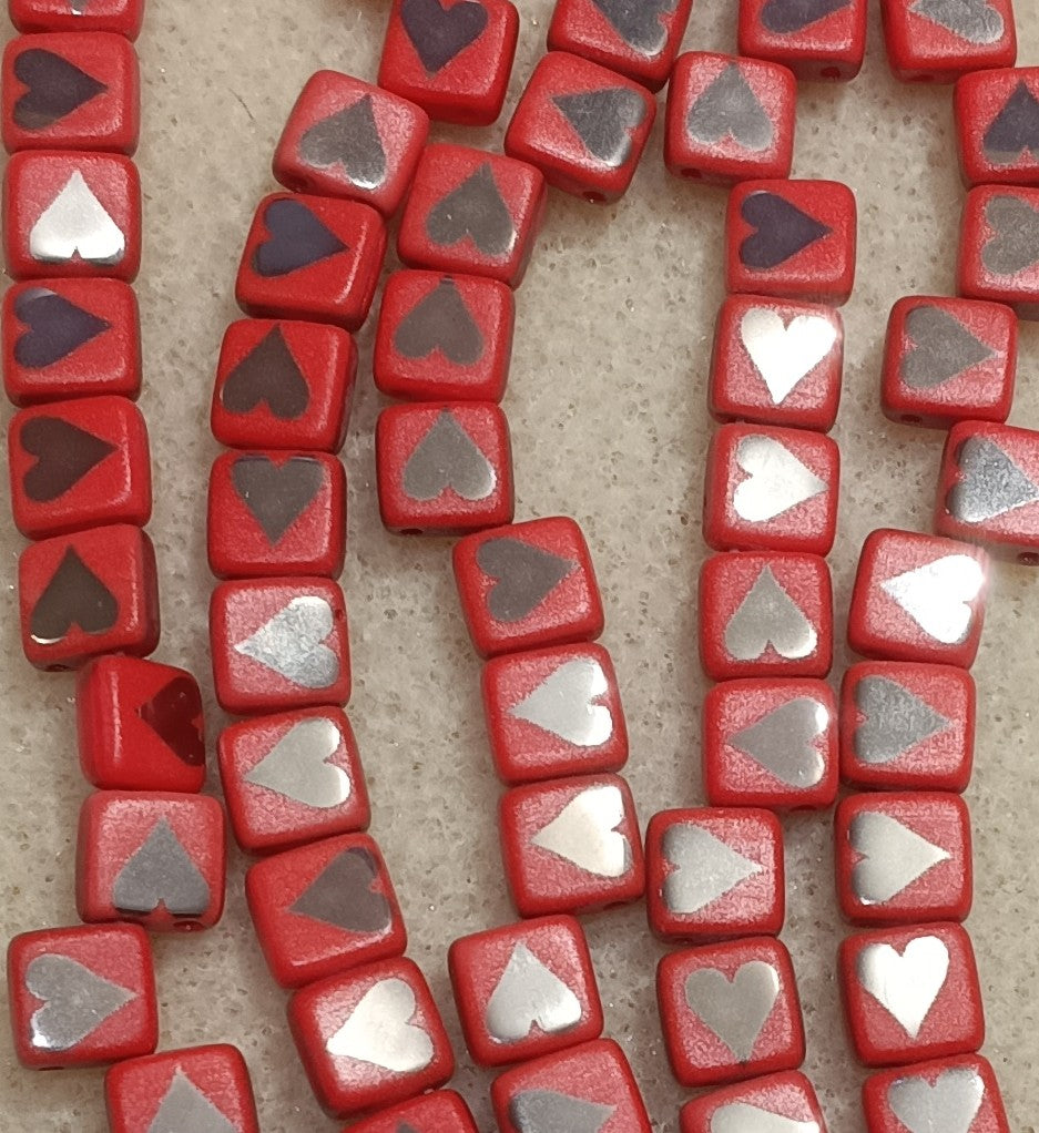 25 x 6mm Czech tiles in Light Red with Laser etched Chrome Hearts