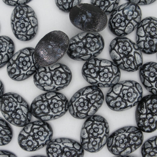 Cab108  - 14x10mm oval cabochon from Preciosa in Black with White flowers (vintage)